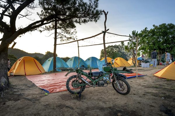 Tents and motorbike in camp in nature